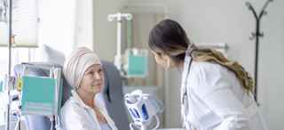 Comforting doctor advising attentive patient