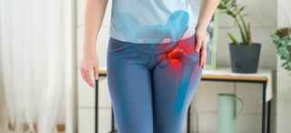 Person holding hip in pain, with hip bones highlighted