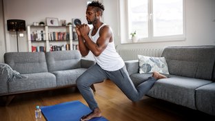 Man at home doing split squats