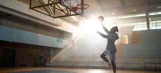 Person playing basketball in a gym