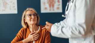 Comforting doctor advising attentive patient