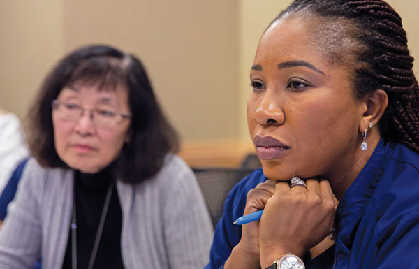 Two female nurses listening