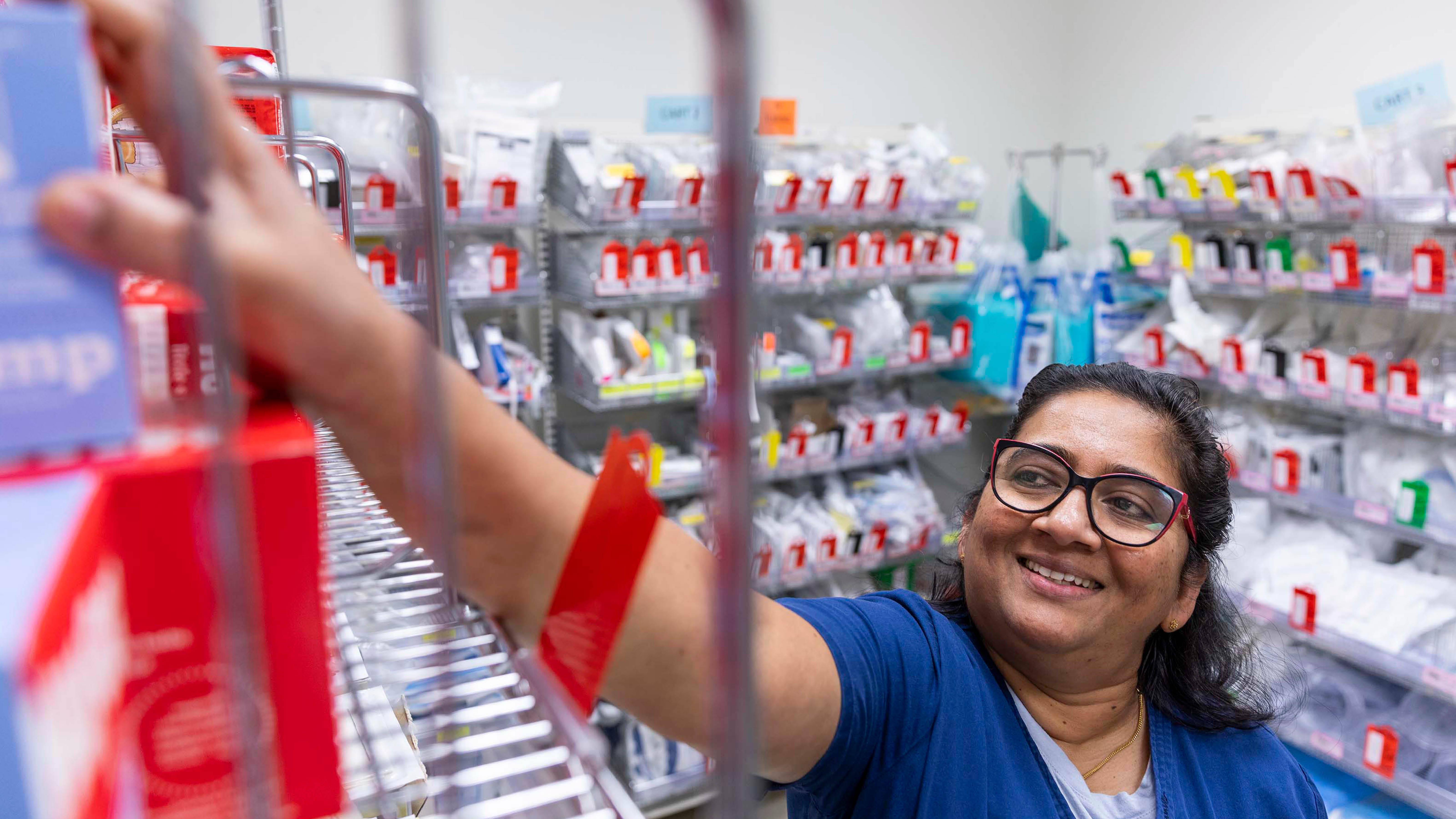 Nurse reaching for something in a supply closet