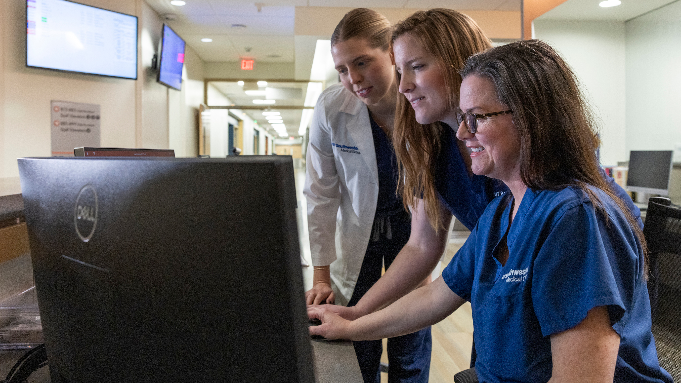 Three nurses looking at a computer