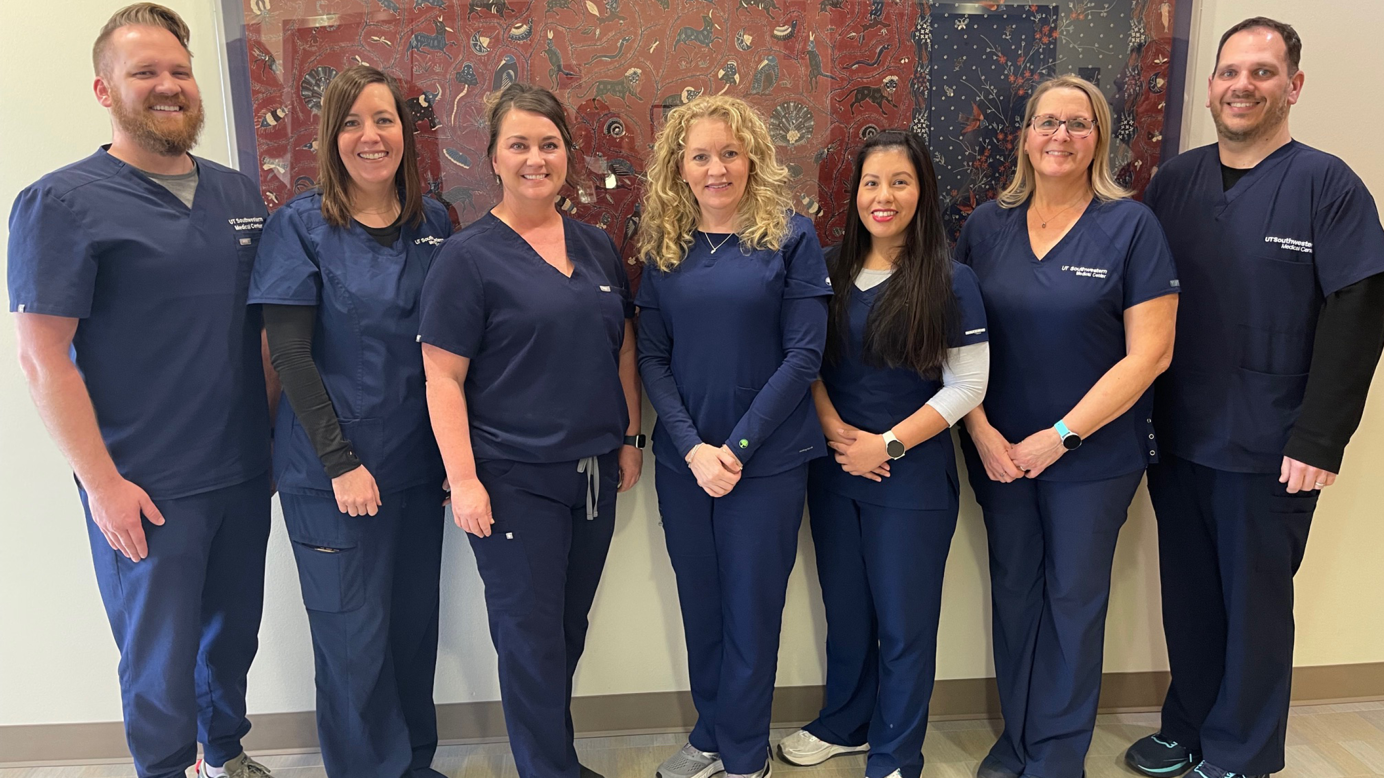 Seven nurses standing in a line for a group photo