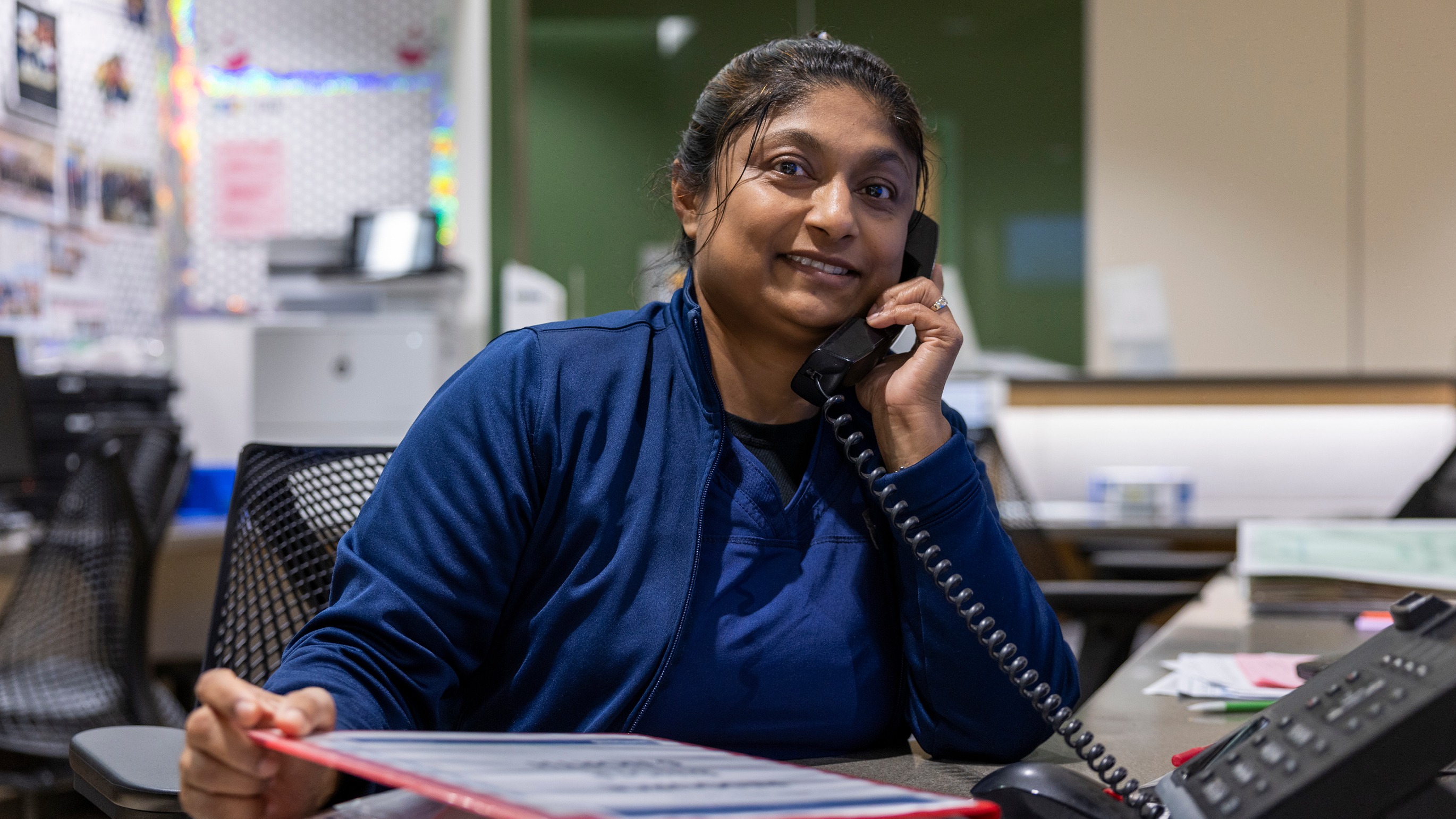 Nurse on phone at her station