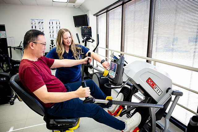 Patient working in the Cardiac Rehabilitation facility on a rowing machine