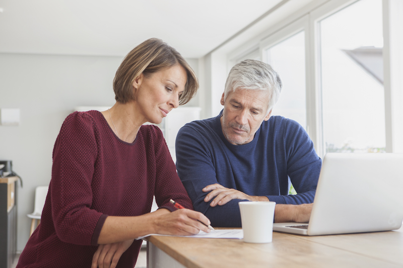 Couple reviewing documents together at home