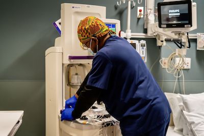 A caring nurse attending to a patient in a hospital setting.