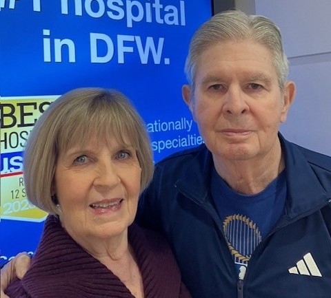 Sharon and Dick Nash standing in front of sign for UT Southwestern
