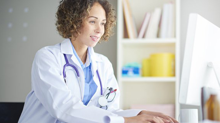 Doctor working on a computer at a desk