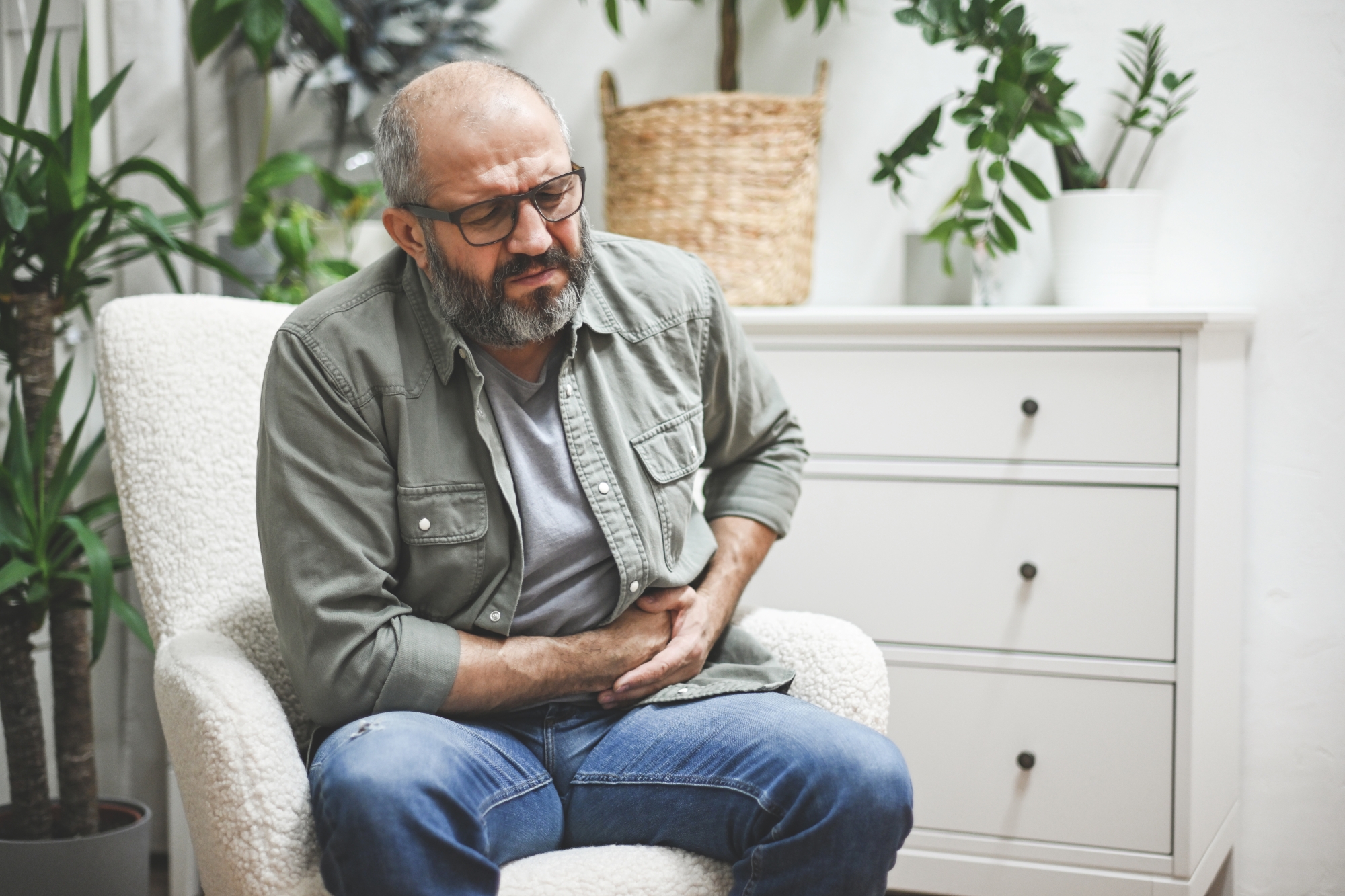 Man clutching stomach in pain