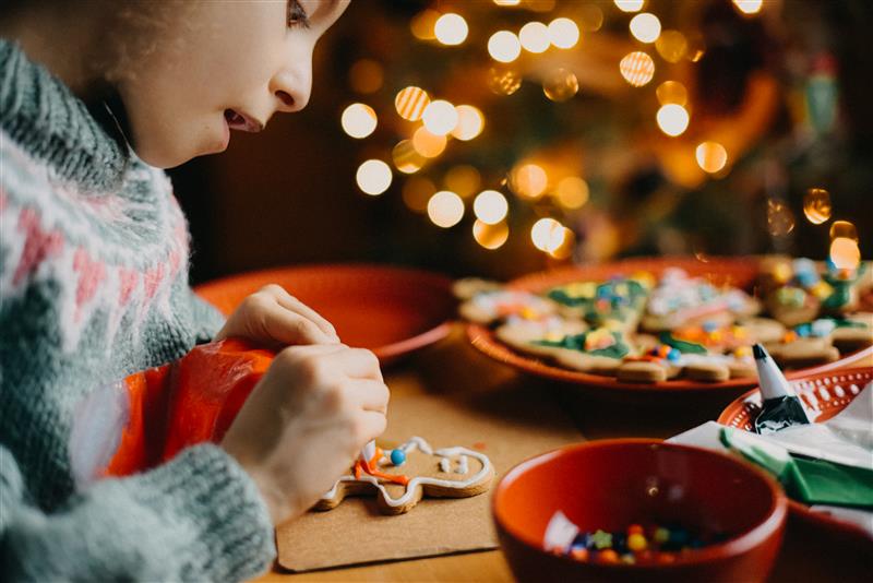 Child decorating gingerbread cookie