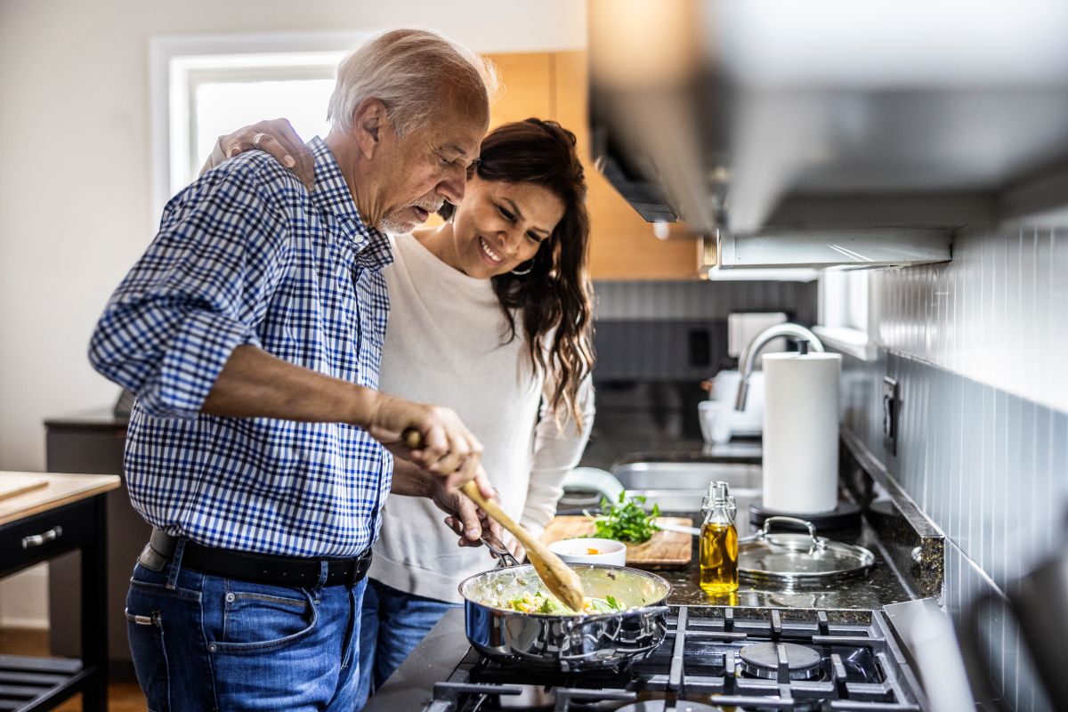 Couple cooking in kitchen.
