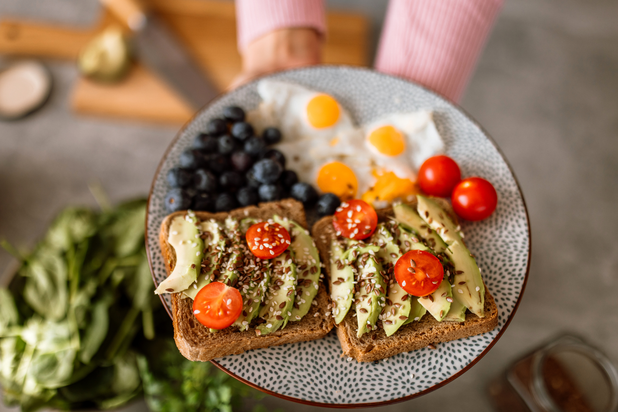 Avocado toast with eggs, berries, and tomatoes
