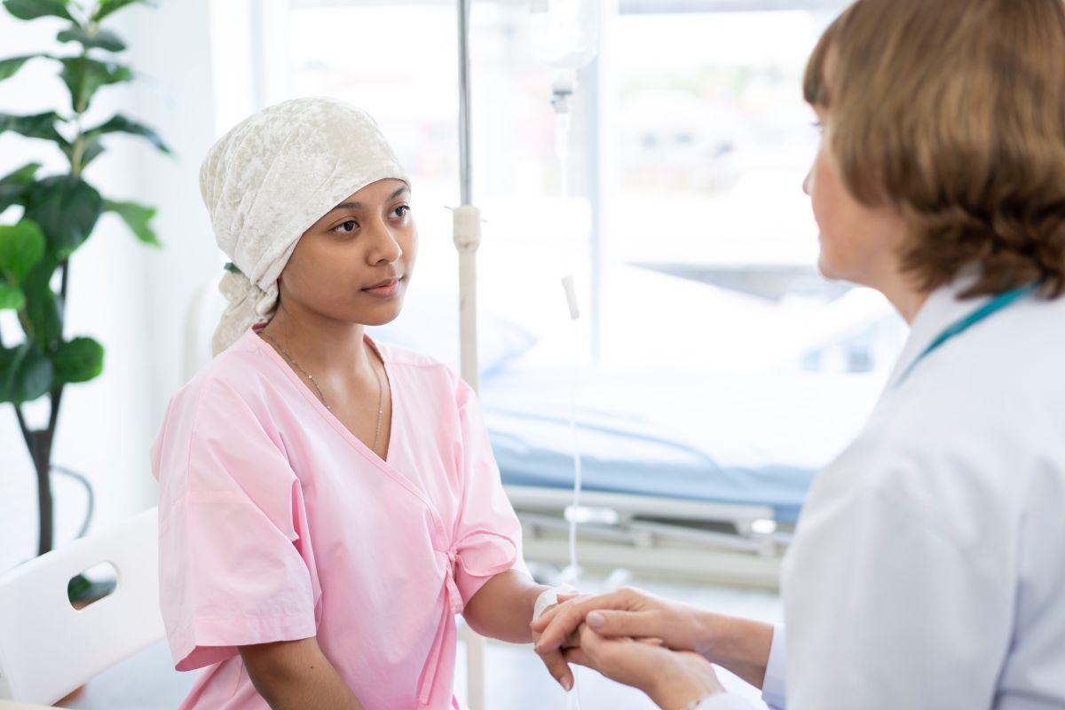 A young cancer patient talks to her doctor.