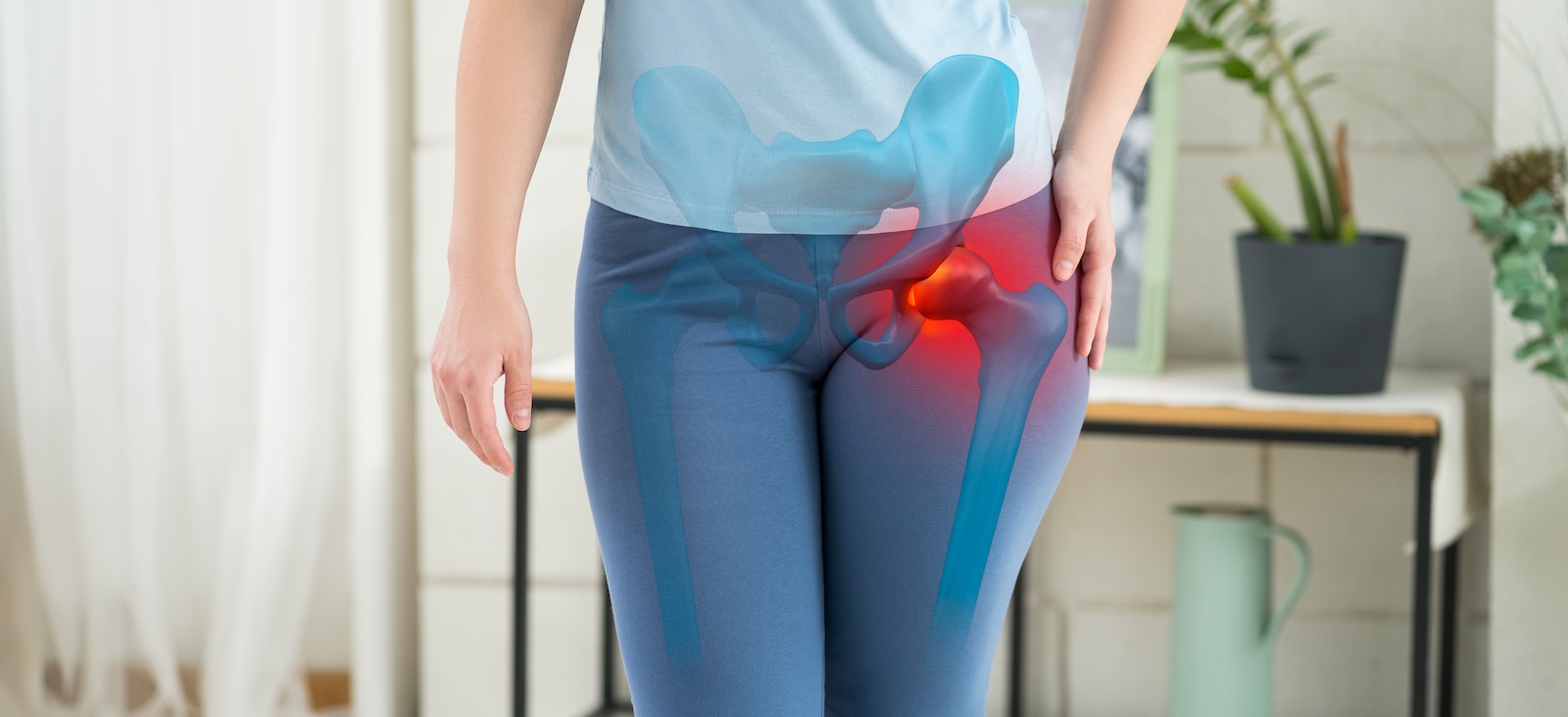 Person holding hip in pain, with hip bones highlighted