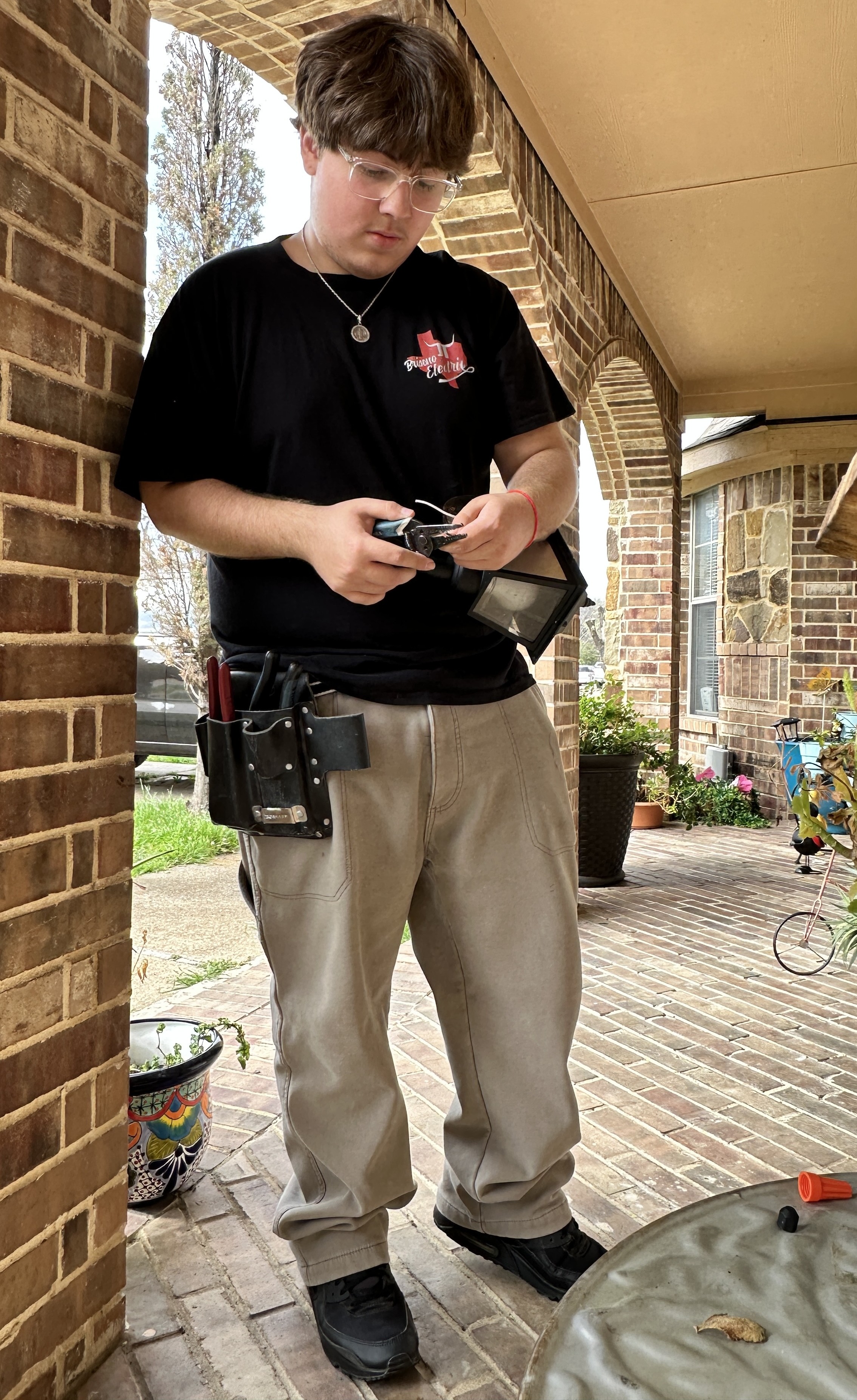 Patient Kevin Briseno replaces a porch light as part of his job as an electrician