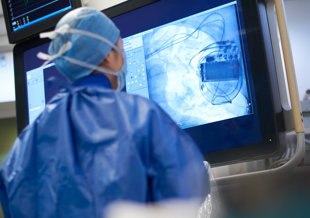 Doctor reviewing data on a monitor.