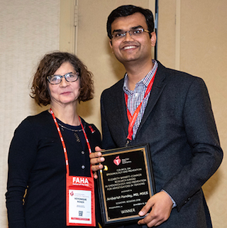 Dr. Pandey holding the  Elizabeth Barrett-Connor Research Award for Early Career Investigators
