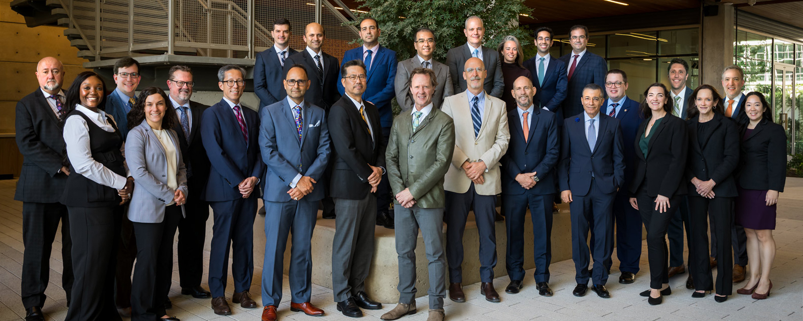 A group of Plastic Surgery faculty standing together posing for a group photo.