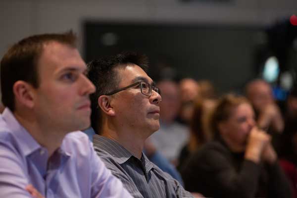 Audience members attentively listening during a town hall meeting
