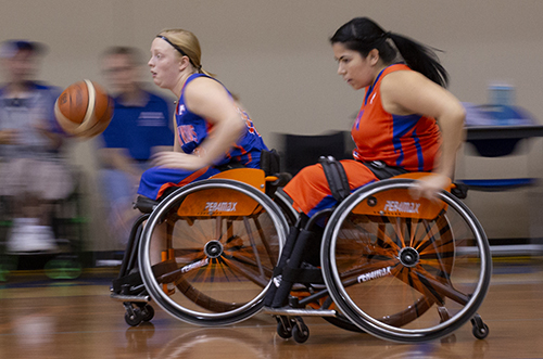 Athletes participate in a competitive wheelchair basketball game, showcasing their skills and teamwork.