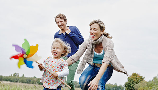 Happy family playing outdoors