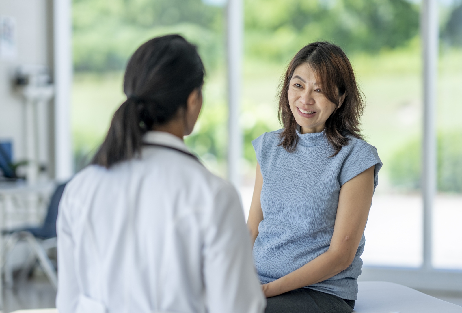 A doctor talks with a patient in the office about test results