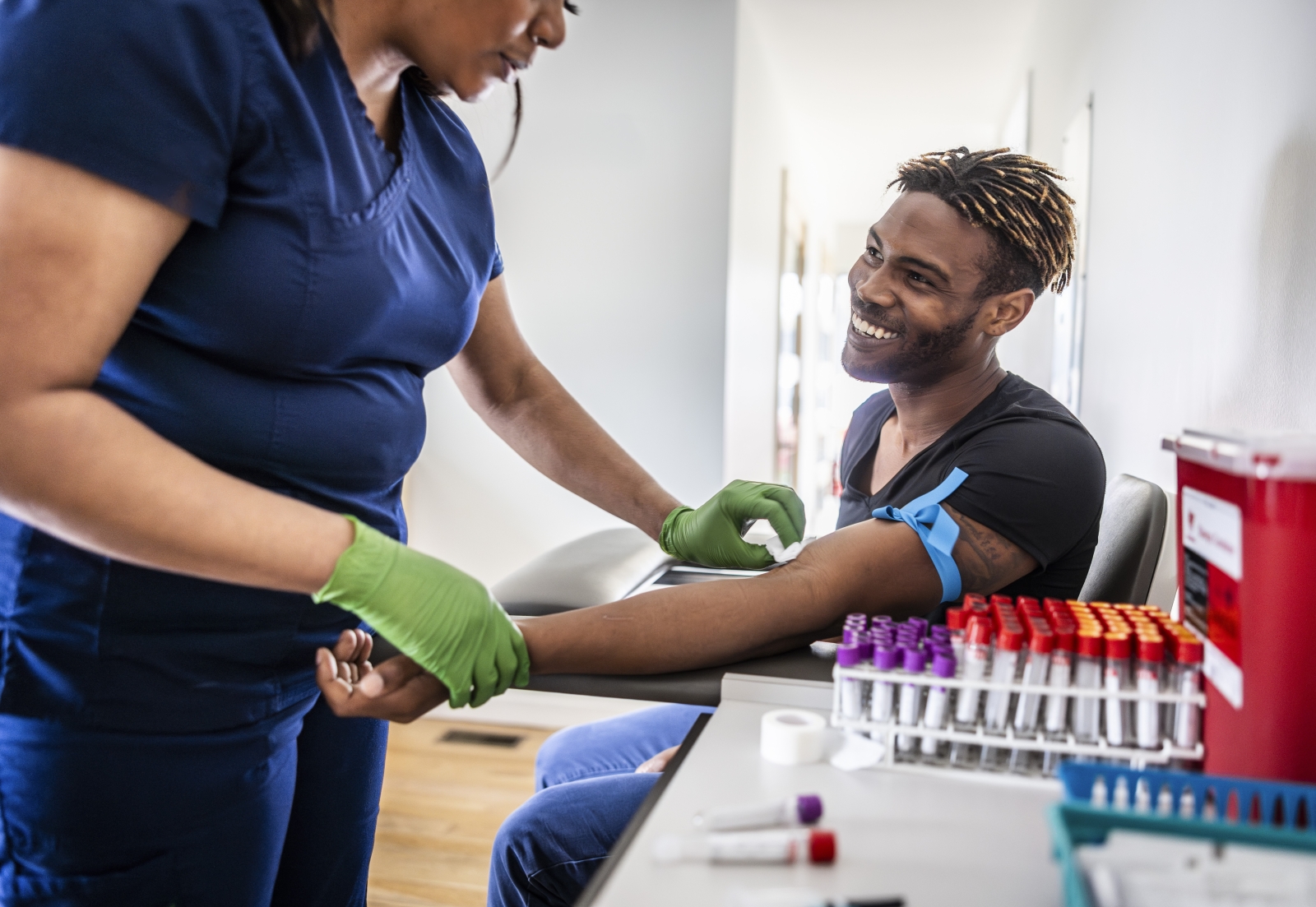 Nurse prepping patient to have blood drawn