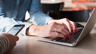 Person sitting in front of a computer typing