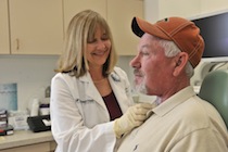 physician checking a patient's throat