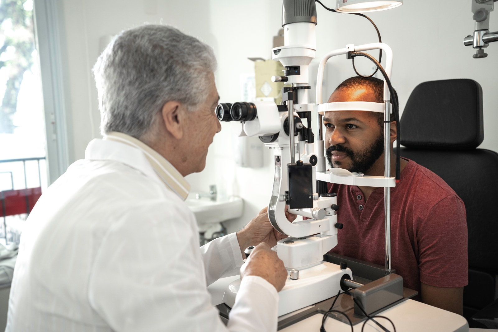 Eye doctor examining patient's eye