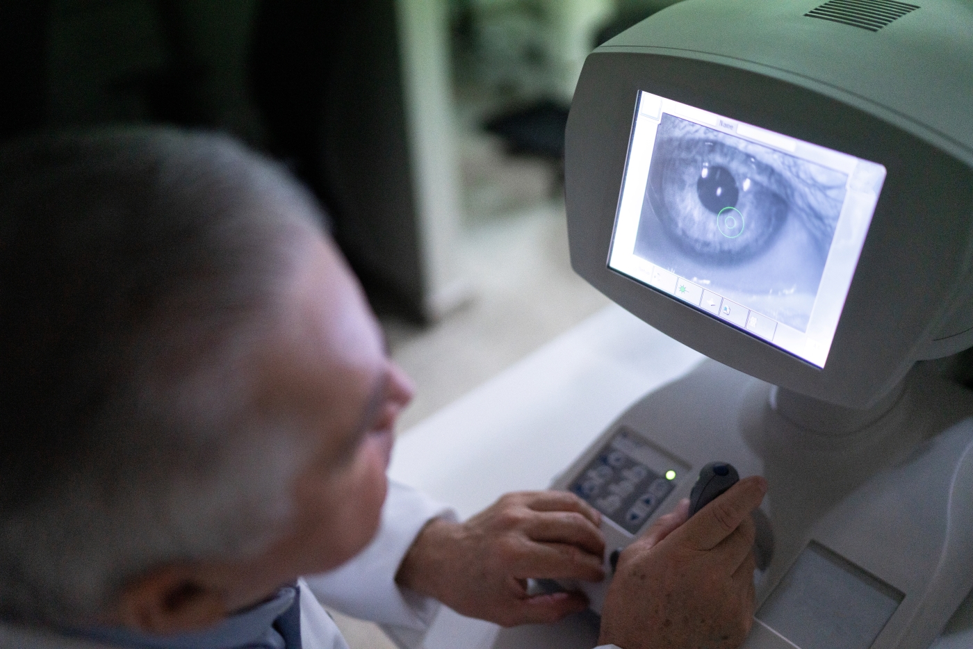 Doctor examining eye on machine