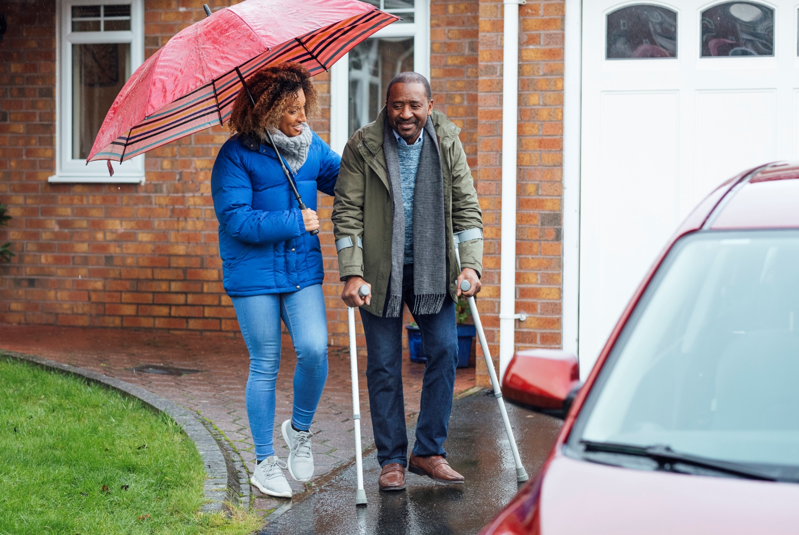 older man gets help from woman walking to car