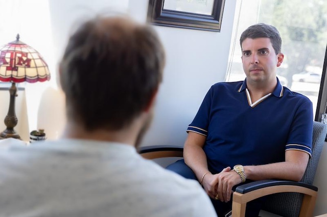 man talking with a provider in a warm office setting.