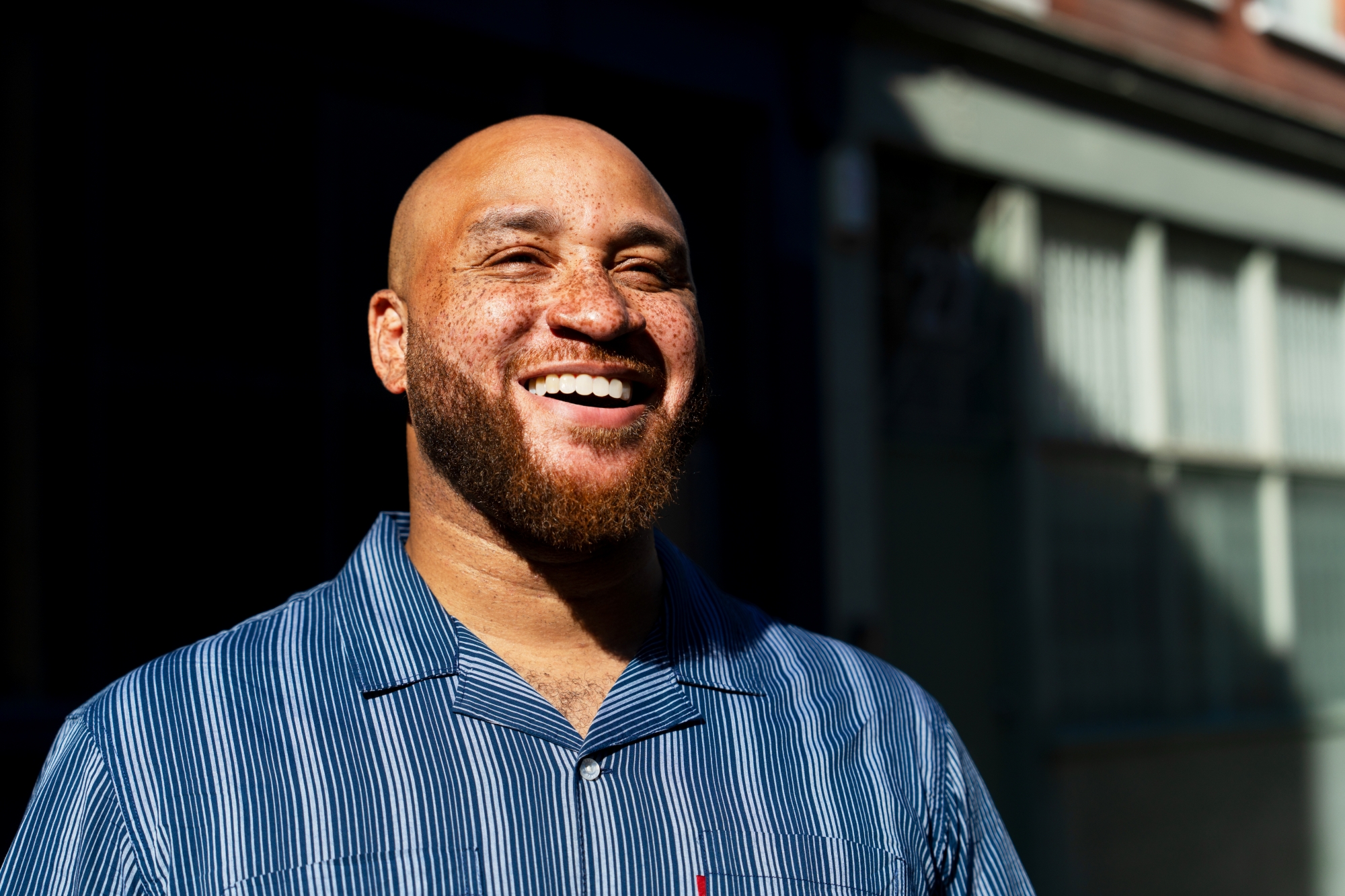 A man shown from the shoulders up and smiling