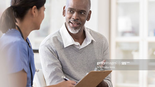 Male patient speaking with female doctor