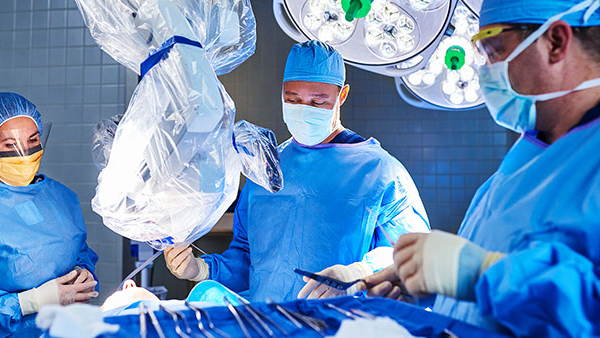 Doctors performing surgery in an operating room