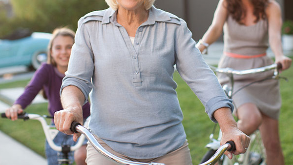 Three generations of women riding bicycles together