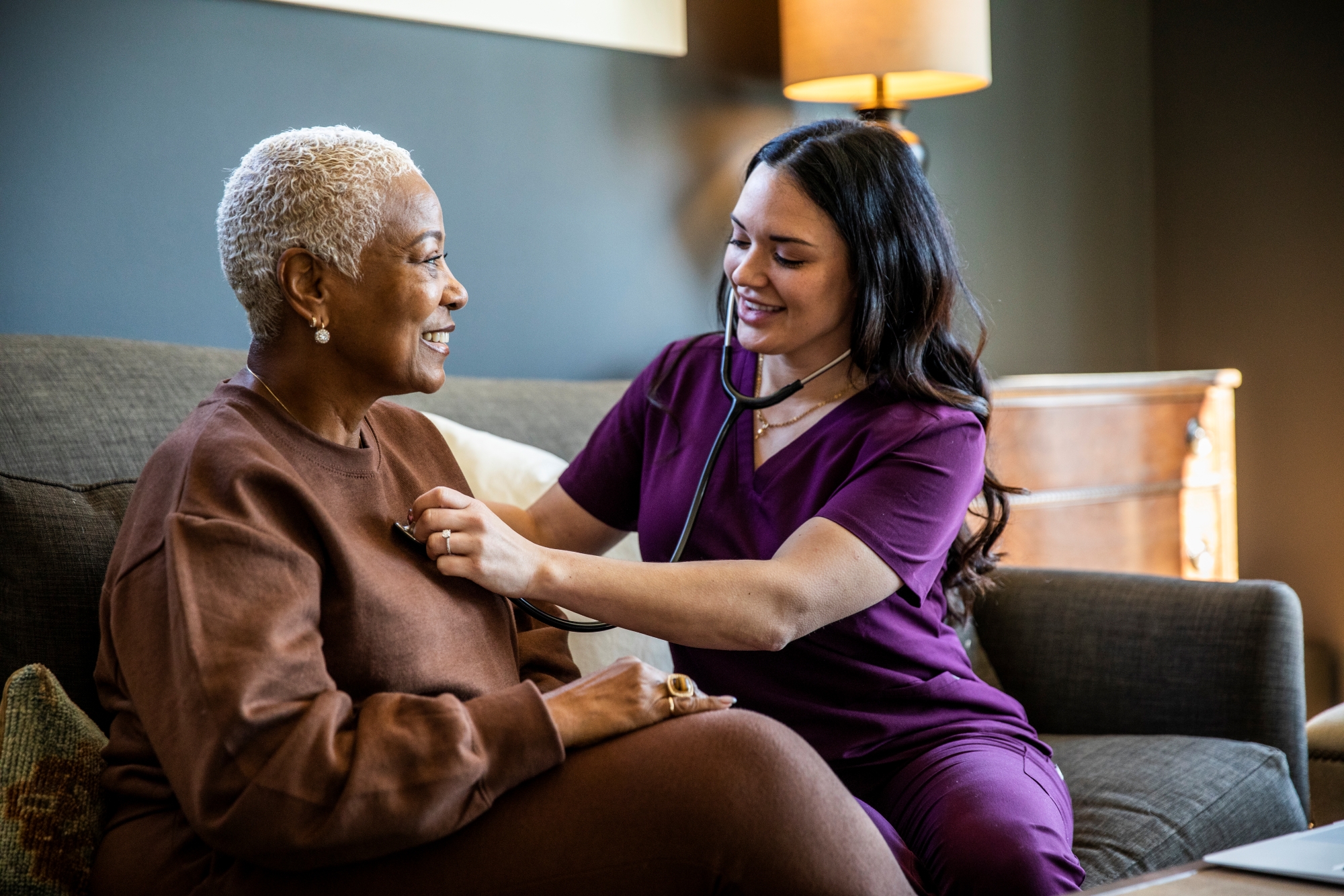 Nurse checking patient's heart rate with stethoscope