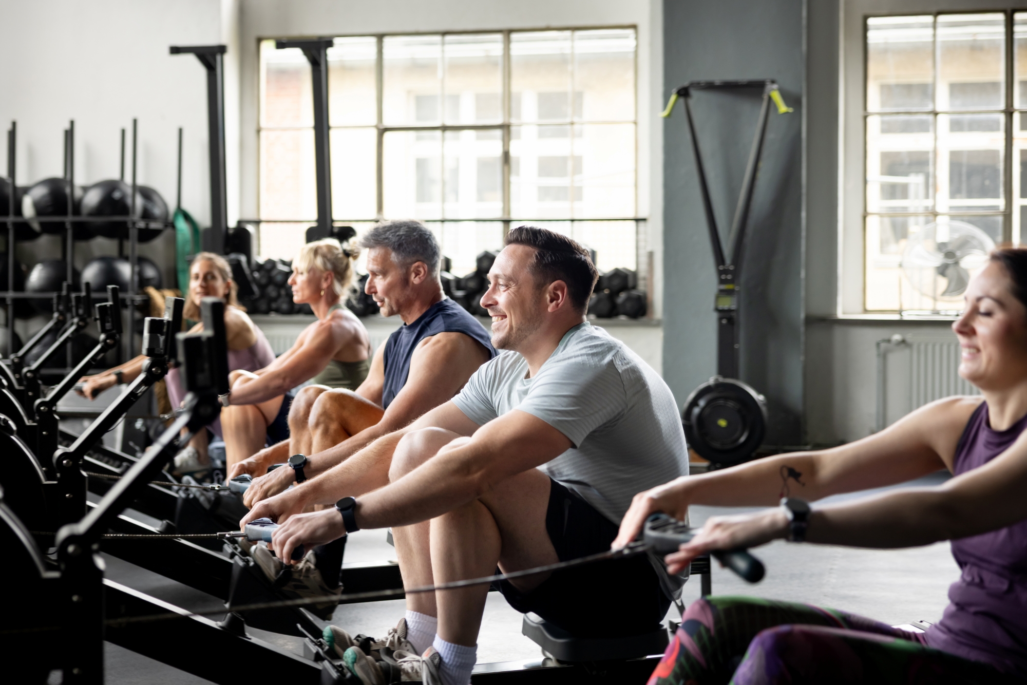 People exercising on rowing machines at a fitness center
