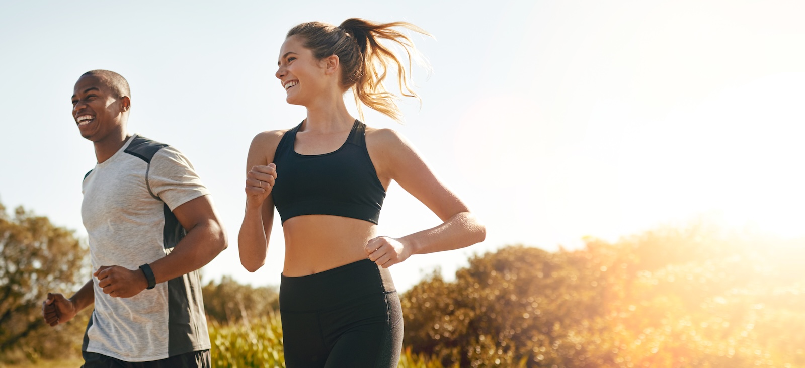 Two people jogging on a sunny day