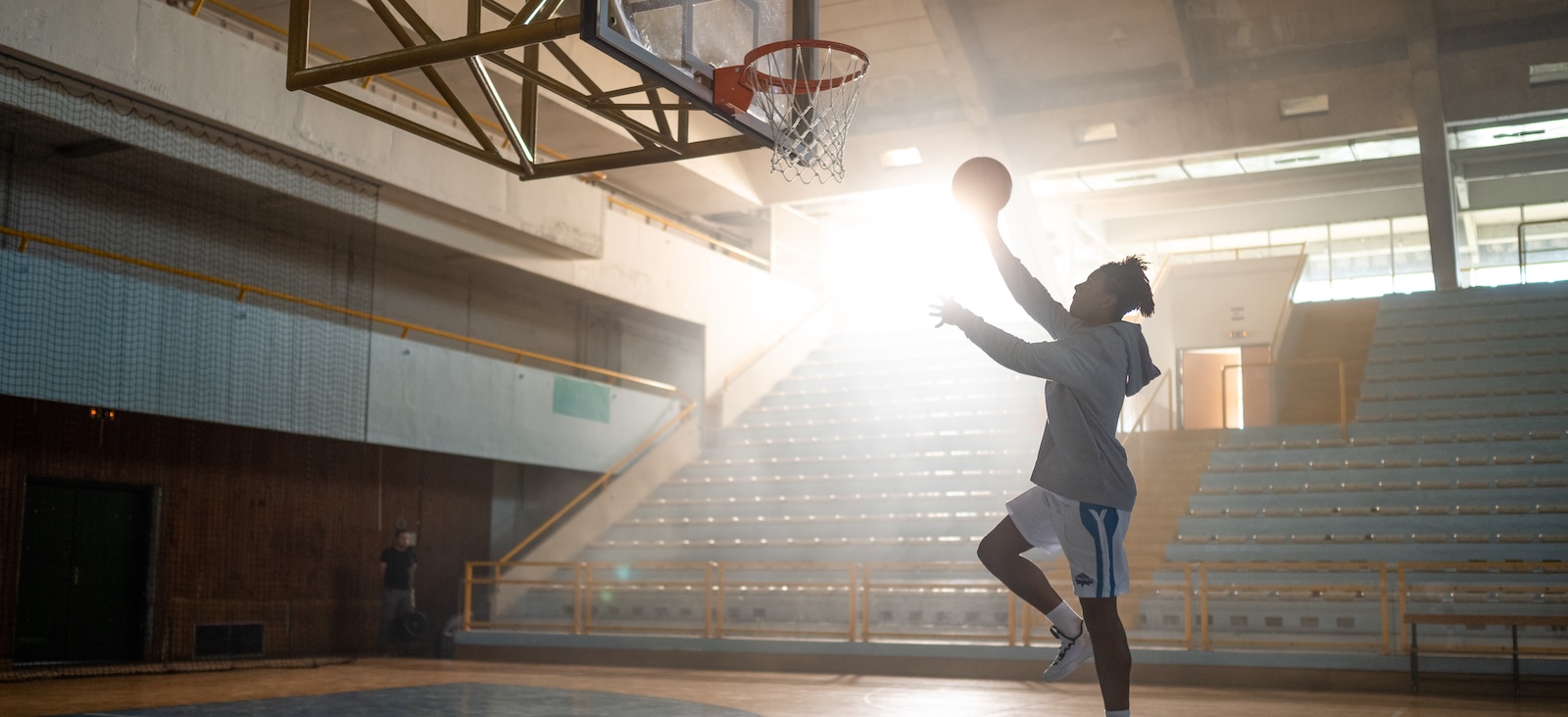 Person playing basketball in a gym