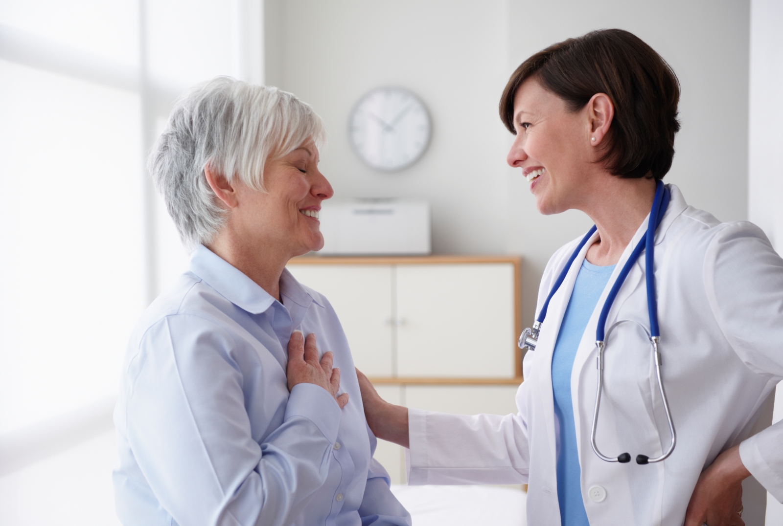 older female patient talking with female doctor
