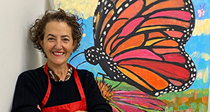 Female artist with butterfly painting