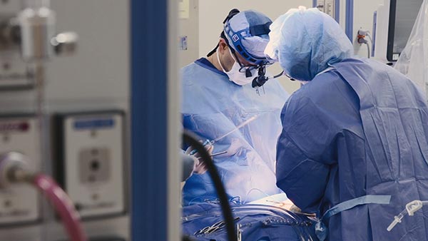 Surgeons performing a cardiovascular procedure in an operating room