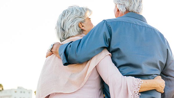 An older couple embracing