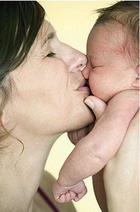 mother kissing baby