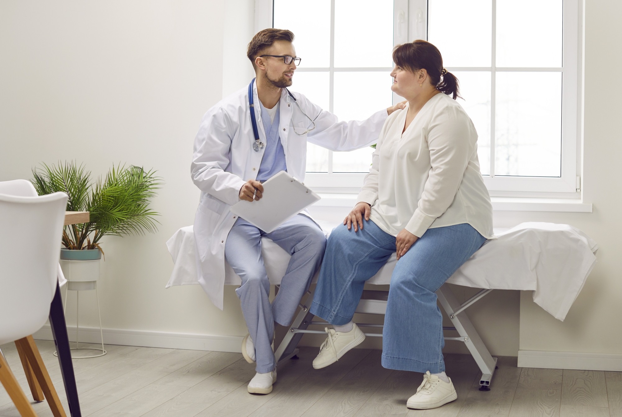 patient with obesity talking with doctor